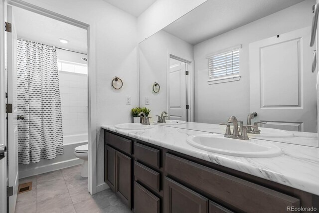 1168 Elbridge Dr, Elizabeth, CO 80107 - bathroom with double vanity, toilet, and shower / tub combo with curtain