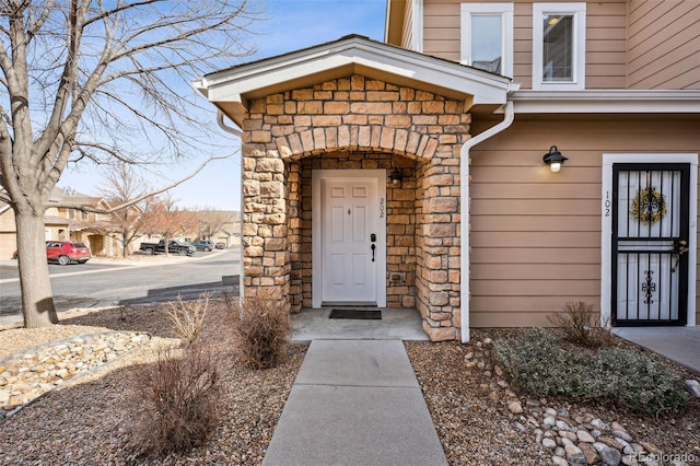 property entrance featuring stone siding