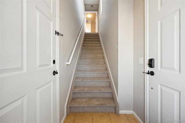 staircase with tile patterned flooring and baseboards