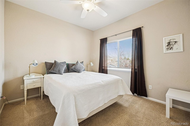 carpeted bedroom with a ceiling fan and baseboards