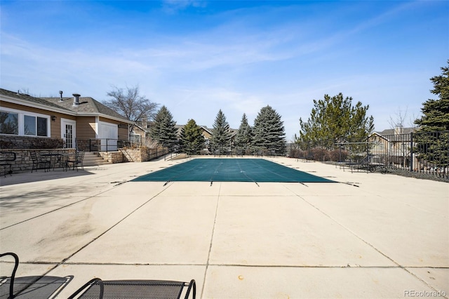 community pool featuring a patio and fence