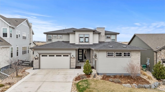 prairie-style house featuring a garage, driveway, and fence