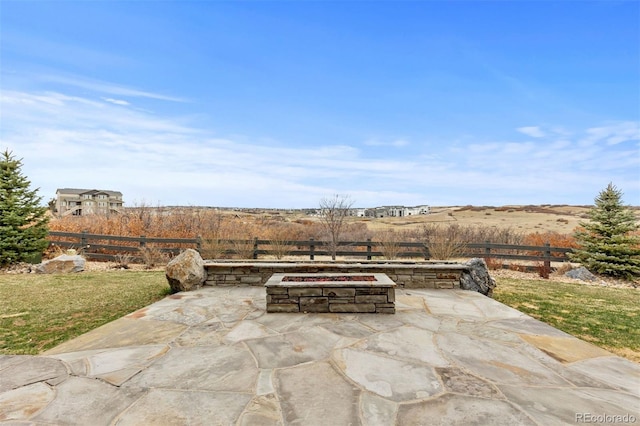 view of patio / terrace with a fire pit and fence