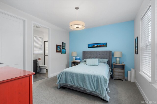 7077 Copper Sky Cir, Castle Pines, CO 80108 - bedroom featuring multiple windows, baseboards, carpet, and ensuite bath