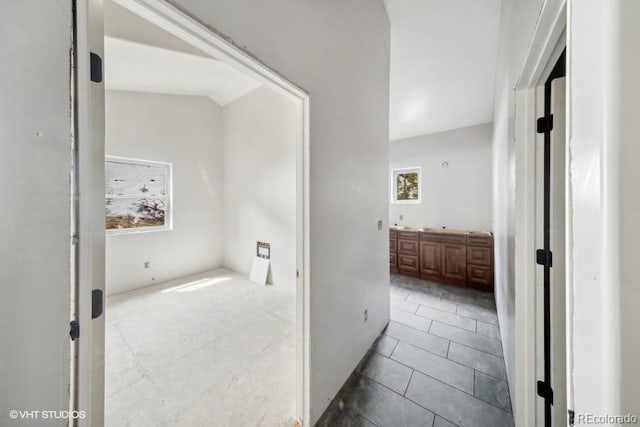 hall featuring a wealth of natural light and tile floors