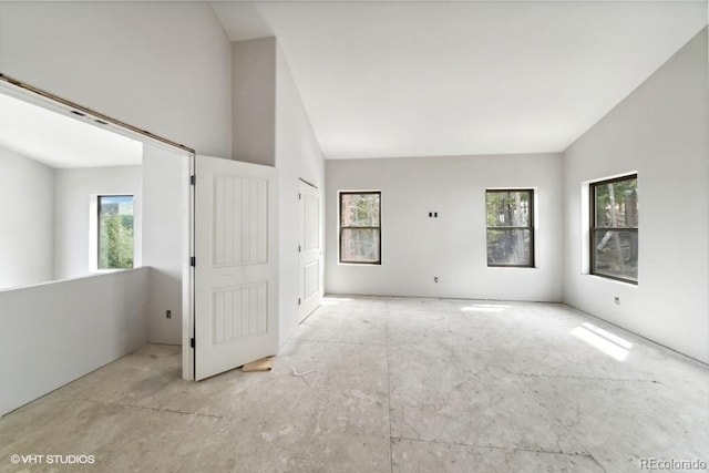 unfurnished living room featuring vaulted ceiling