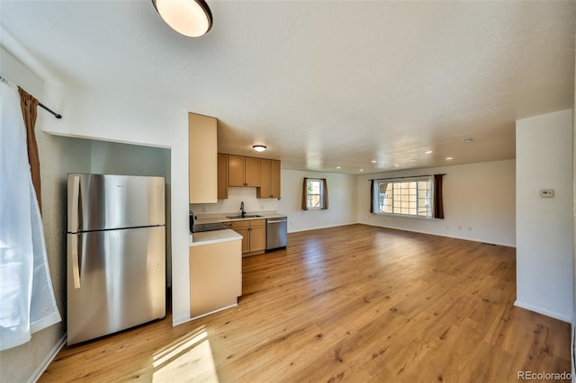 804 Wapiti Dr, Fraser, CO 80442 - kitchen featuring stainless steel appliances, light countertops, a sink, open floor plan, and light wood-style floors
