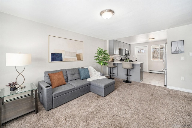 living room with baseboards, a baseboard radiator, light tile patterned floors, and light colored carpet