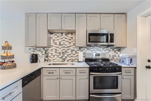 kitchen with a sink, gray cabinetry, and appliances with stainless steel finishes