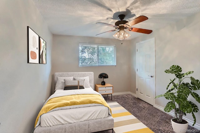 bedroom featuring a textured ceiling, baseboards, carpet, and ceiling fan