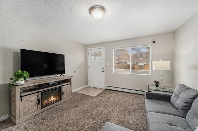 living area with carpet flooring, baseboards, a glass covered fireplace, and a baseboard heating unit