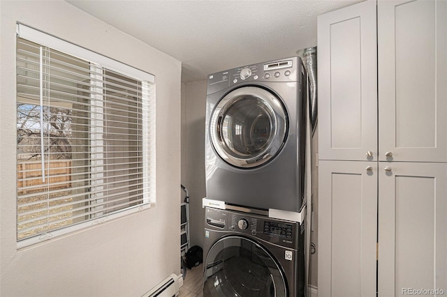 laundry room featuring stacked washing maching and dryer and cabinet space