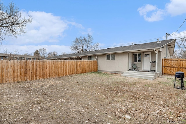 rear view of house featuring fence private yard
