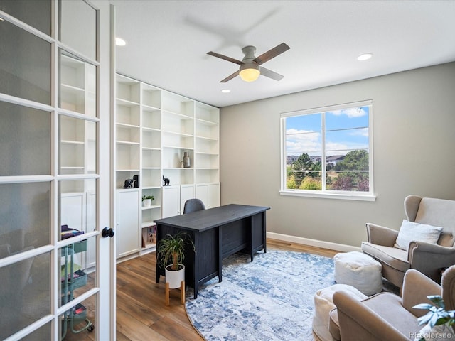 office area featuring dark hardwood / wood-style floors and ceiling fan