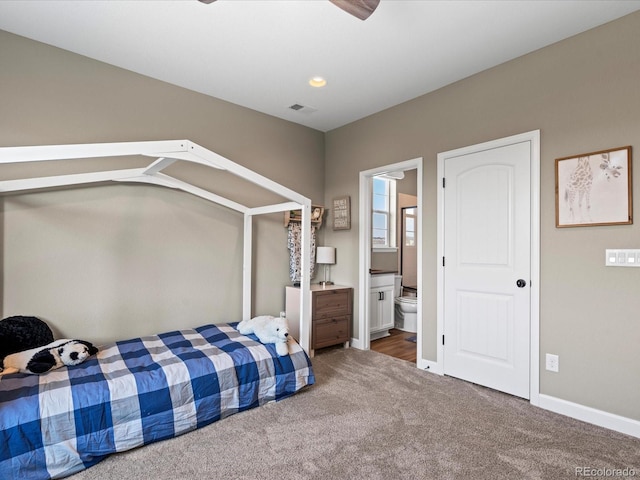 bedroom with carpet flooring, ensuite bathroom, and vaulted ceiling