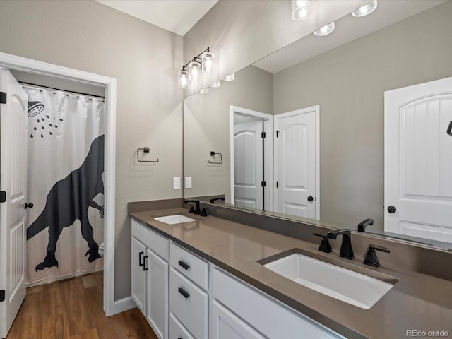 bathroom with hardwood / wood-style flooring, vanity, and a shower with curtain