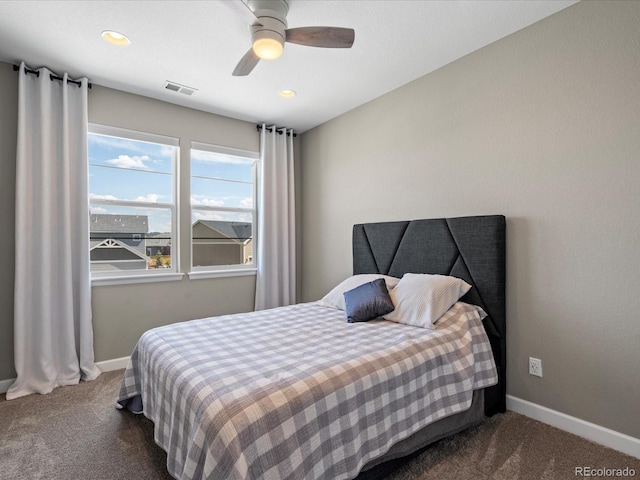 bedroom featuring ceiling fan and dark carpet