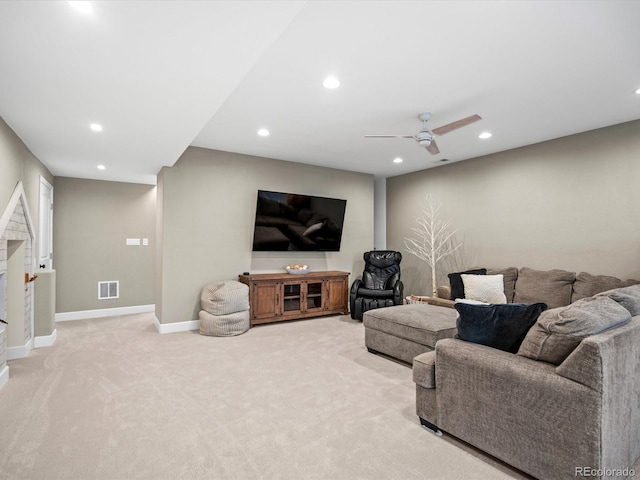 carpeted living room with ceiling fan