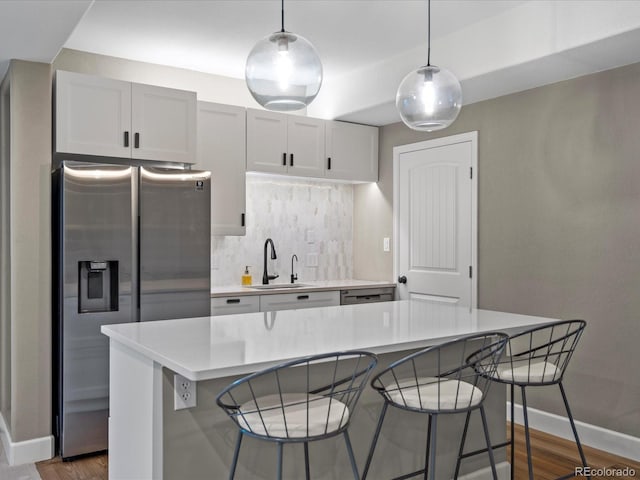 kitchen featuring sink, stainless steel appliances, a kitchen island, dark hardwood / wood-style flooring, and white cabinets