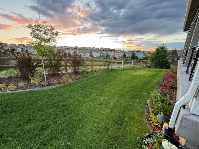 view of yard at dusk