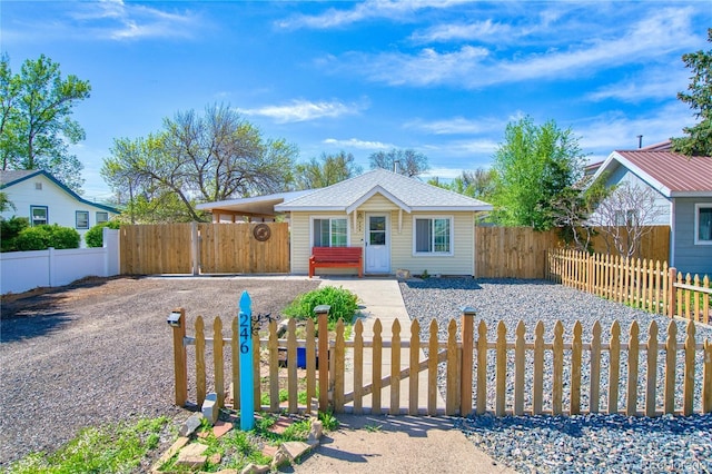 view of front of house with a fenced front yard and a gate