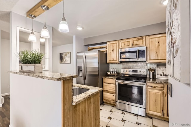 kitchen featuring light stone counters, appliances with stainless steel finishes, decorative backsplash, light brown cabinetry, and pendant lighting