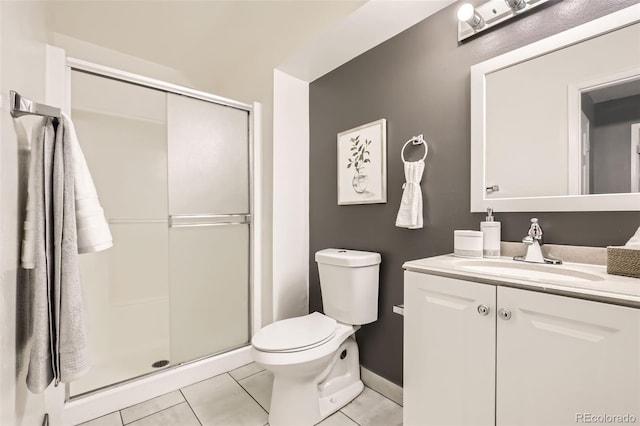 bathroom featuring toilet, a stall shower, vanity, tile patterned flooring, and baseboards