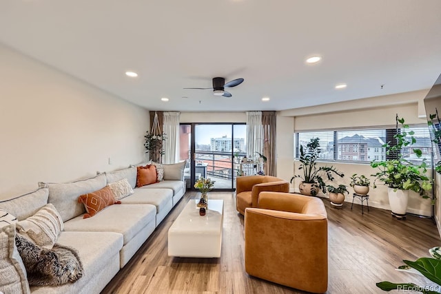 living area featuring a view of city, light wood-type flooring, and recessed lighting