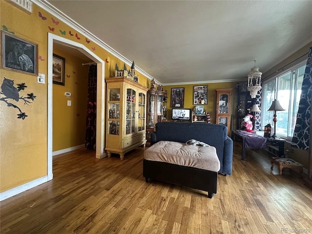 260 Sheridan Blvd, Denver, CO 80226 - living area with wood finished floors, crown molding, arched walkways, baseboards, and a chandelier
