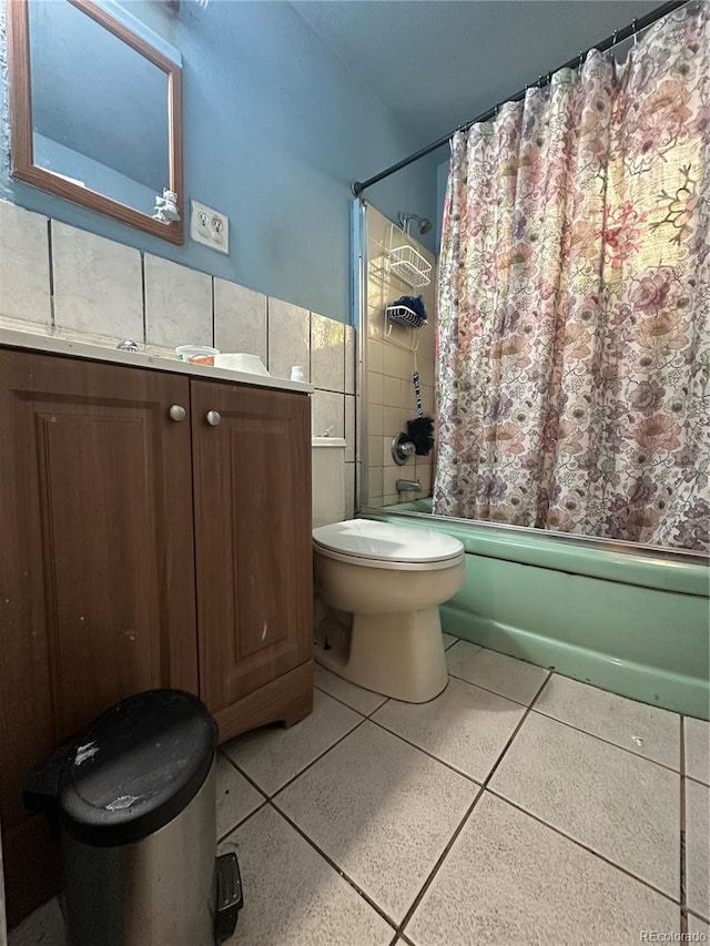 260 Sheridan Blvd, Denver, CO 80226 - full bath featuring tile walls, shower / bath combo, toilet, vanity, and speckle patterned floor