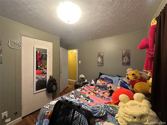 260 Sheridan Blvd, Denver, CO 80226 - bedroom with wood finished floors, a textured ceiling, and baseboards