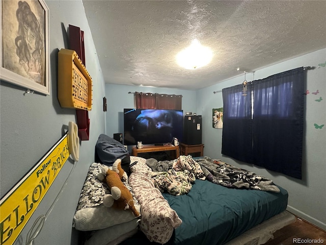260 Sheridan Blvd, Denver, CO 80226 - bedroom featuring a textured ceiling and baseboards