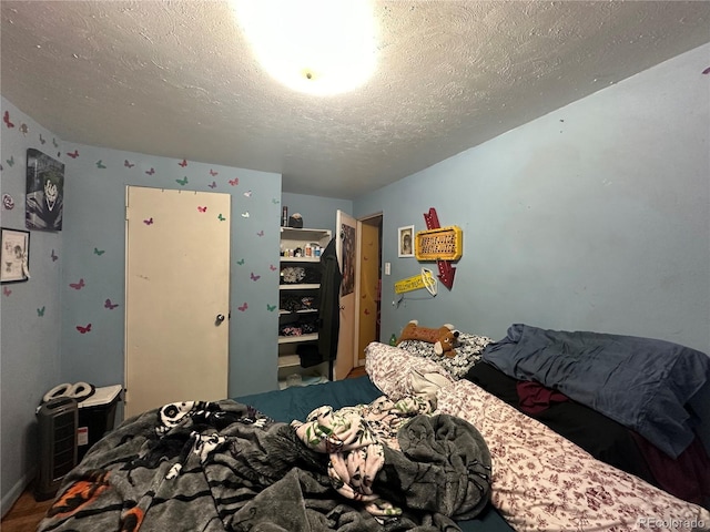 260 Sheridan Blvd, Denver, CO 80226 - bedroom featuring a textured ceiling and wood finished floors