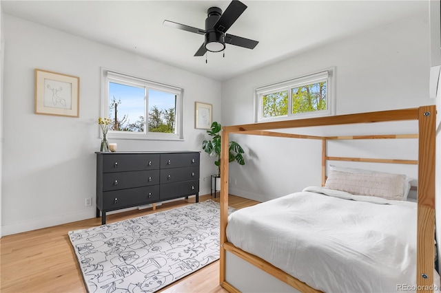 3103 W Bellewood Dr, Englewood, CO 80110 - bedroom featuring multiple windows, baseboards, wood finished floors, and a ceiling fan