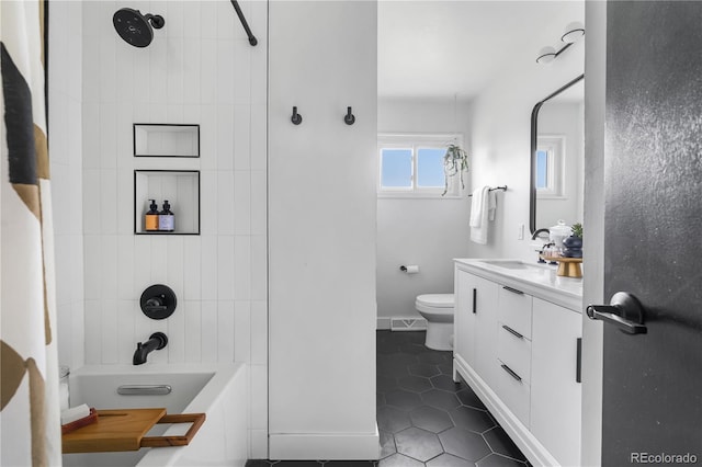 3103 W Bellewood Dr, Englewood, CO 80110 - bathroom featuring tile patterned flooring, toilet, vanity, baseboards, and shower / bath combination