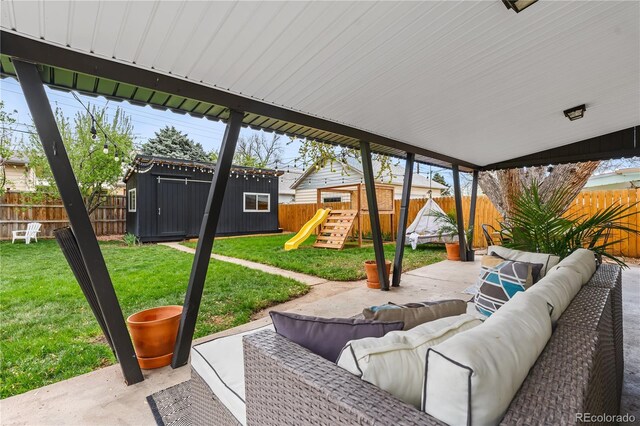 3103 W Bellewood Dr, Englewood, CO 80110 - view of patio / terrace with outdoor lounge area, a playground, an outbuilding, and a storage shed