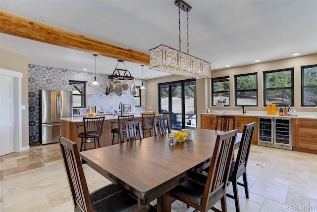 dining area with wine cooler, recessed lighting, french doors, beam ceiling, and stone tile flooring