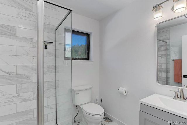 bathroom with toilet, vanity, baseboards, marble finish floor, and a shower stall