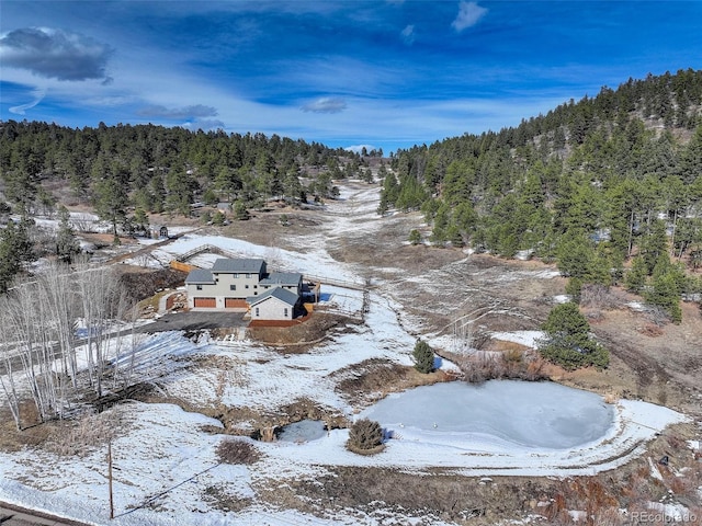 snowy aerial view with a view of trees