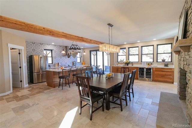 20101 Spring Gulch Rd, Morrison, CO 80465 - dining area featuring stone tile flooring, beverage cooler, a chandelier, beamed ceiling, and recessed lighting