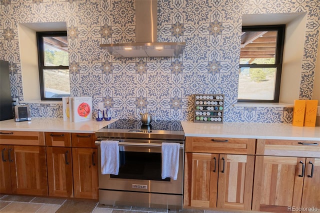 20101 Spring Gulch Rd, Morrison, CO 80465 - kitchen with stainless steel range with electric stovetop, wall chimney exhaust hood, light countertops, and plenty of natural light