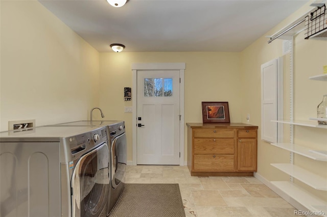 20101 Spring Gulch Rd, Morrison, CO 80465 - laundry room with washing machine and clothes dryer, baseboards, and cabinet space