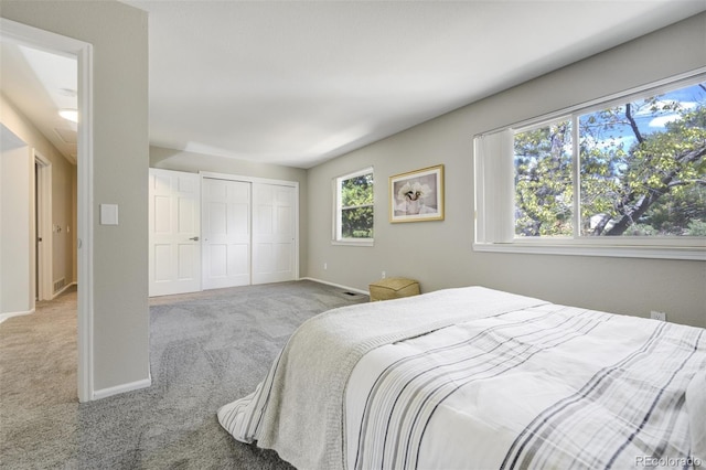 carpeted bedroom with baseboards and a closet