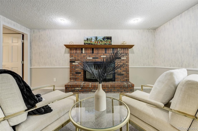 living area featuring a textured ceiling, a fireplace, and baseboards