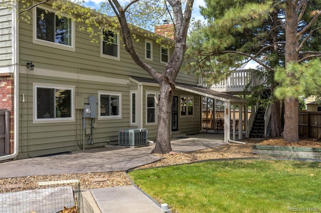 6302 S Ivy Ct, Centennial, CO 80111 - rear view of property featuring cooling unit, a chimney, a patio, stairs, and a deck