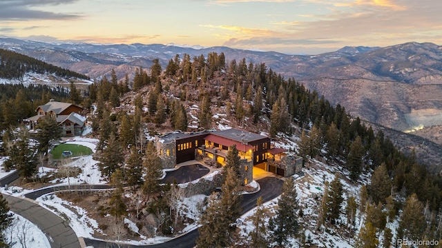 snowy aerial view with a mountain view