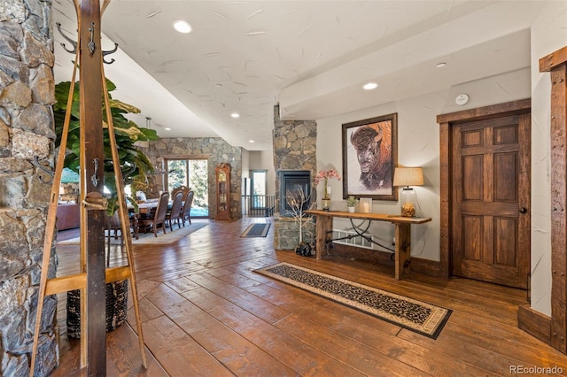 interior space with hardwood / wood-style flooring and a stone fireplace