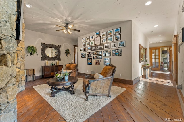 living room with wood-type flooring and ceiling fan