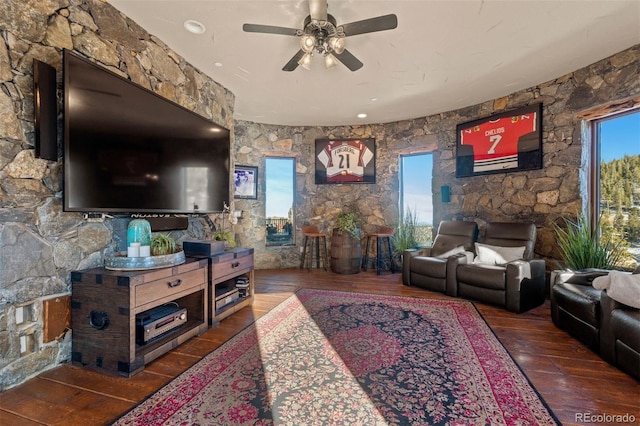 living room with ceiling fan and dark hardwood / wood-style flooring