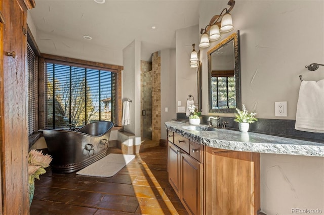 bathroom featuring vanity and shower with separate bathtub